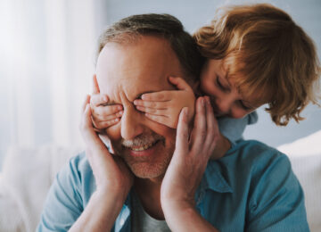 Small,Grandson,Closes,With,Hands,An,Eyes,Of,Grandfather.,Guess